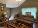 Cozy living room with leather furniture, hardwood floors, and great natural light at 1432 Eagles Nest Cir, Carrollton, GA 30116