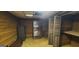 A partially furnished basement with carpet, wood paneling, and storage at 1992 Kunuga Dr, Jonesboro, GA 30236