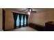 Bedroom with large window, fan, dresser and sheer curtains at 1992 Kunuga Dr, Jonesboro, GA 30236