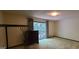 A bright bedroom features sliding glass doors with a leafy backyard view at 1992 Kunuga Dr, Jonesboro, GA 30236