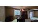 Dining room with decorative chandelier, vintage wallpaper, and adjacent sliding glass doors at 1992 Kunuga Dr, Jonesboro, GA 30236