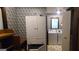 Laundry room with storage cabinets, a washer and dryer set, and patterned wallpaper at 1992 Kunuga Dr, Jonesboro, GA 30236