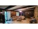 Comfortable living room featuring wood paneling, beamed ceilings, and a large sectional sofa at 1992 Kunuga Dr, Jonesboro, GA 30236