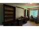 The office has a desk and shelves near a window with outdoor views at 1992 Kunuga Dr, Jonesboro, GA 30236