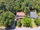 Aerial view showcasing a house nestled among trees with a charming front porch at 4031 E Meadow Dr, Duluth, GA 30096