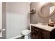 Half-bath features patterned wallpaper, modern vanity, and round mirror at 4031 E Meadow Dr, Duluth, GA 30096