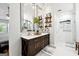 Elegant bathroom boasts double sinks, stylish lighting, and decorative shelving at 4031 E Meadow Dr, Duluth, GA 30096