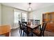 Bright dining room featuring a dark wood table with seating for six and natural light from a nearby window at 4031 E Meadow Dr, Duluth, GA 30096