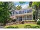 Charming two-story home featuring a welcoming front porch and well-maintained landscaping with mature trees at 4031 E Meadow Dr, Duluth, GA 30096