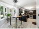 Bright kitchen with dark cabinets, stainless steel appliances, granite countertops, and breakfast nook with lots of sunlight at 4031 E Meadow Dr, Duluth, GA 30096