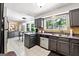 Spacious kitchen featuring an island, stainless steel dishwasher, and view of the living area at 4031 E Meadow Dr, Duluth, GA 30096