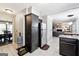 Open kitchen showcasing dark cabinets, stainless steel refrigerator, and view into the living area at 4031 E Meadow Dr, Duluth, GA 30096