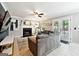 Spacious living room with a fireplace, neutral walls, large gray sofa and door leading to outdoor space at 4031 E Meadow Dr, Duluth, GA 30096