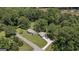 Aerial view of a beautiful property with a home and detached garage nestled among mature trees at 204 First St, Bowdon, GA 30108