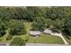 Aerial perspective of a charming home and detached garage surrounded by lush greenery and trees at 204 First St, Bowdon, GA 30108