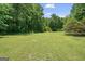 Expansive backyard featuring lush green grass and mature trees at 204 First St, Bowdon, GA 30108