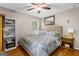 Cozy bedroom featuring a plush bed, wooden floors, and decorative shelving, perfect for relaxation at 204 First St, Bowdon, GA 30108