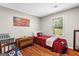 Bedroom with hardwood floors, American flag art, and window at 204 First St, Bowdon, GA 30108