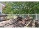 Outdoor deck with a grill and chairs, perfect for relaxing at 204 First St, Bowdon, GA 30108