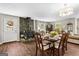 Cozy dining room featuring a wood-burning stove with a stone surround and a lovely chandelier above the table at 204 First St, Bowdon, GA 30108