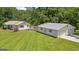 Wide shot of the home's exterior and detached garage featuring well-kept lawn and convenient rear deck at 204 First St, Bowdon, GA 30108
