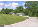 Inviting property showcasing a well-maintained home and a detached two-car garage on a lush lot at 204 First St, Bowdon, GA 30108