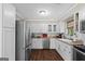 Modern kitchen featuring stainless steel appliances, white cabinetry, and a functional layout for efficient cooking at 204 First St, Bowdon, GA 30108