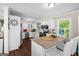 Bright kitchen with white cabinetry, stainless steel appliances, and a peninsula with bar seating at 204 First St, Bowdon, GA 30108