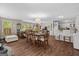 Open-concept layout with living, dining, and kitchen areas featuring wood floors and plentiful natural light at 204 First St, Bowdon, GA 30108