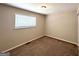 This cozy bedroom features neutral colored walls, carpeted floors, and natural light at 3730 Stephanie Sw Dr, Atlanta, GA 30331