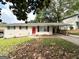 Charming single-story white brick home with a bright red front door and a covered carport at 3730 Stephanie Sw Dr, Atlanta, GA 30331