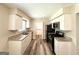 Modern galley kitchen featuring granite countertops, stainless steel appliances, and sleek white cabinetry at 3730 Stephanie Sw Dr, Atlanta, GA 30331