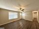 Bright living room boasts a ceiling fan, neutral paint, wood-look flooring and great natural light at 3730 Stephanie Sw Dr, Atlanta, GA 30331