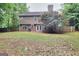 Spacious backyard with mature trees, a patio and a wooden fence at 5765 Woodstone Dr, Cumming, GA 30028
