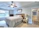 Calm bedroom features a tray ceiling, queen bed, and bedside tables with lamps at 5765 Woodstone Dr, Cumming, GA 30028