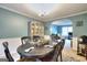 Charming dining room with a display cabinet, oval table, and an open archway to the living space at 5765 Woodstone Dr, Cumming, GA 30028