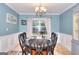 Inviting dining room with an oval table, black chairs, and a window view at 5765 Woodstone Dr, Cumming, GA 30028