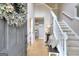 Inviting foyer with wood floors, a staircase, neutral walls and a view into the dining and kitchen at 5765 Woodstone Dr, Cumming, GA 30028