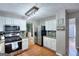 Charming kitchen featuring stainless steel appliances, granite countertops, and a view to the dining and living areas at 5765 Woodstone Dr, Cumming, GA 30028