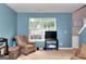 Cozy room with a window view, comfortable armchair, and home gym equipment at 5765 Woodstone Dr, Cumming, GA 30028