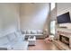 Cozy living room features a brick fireplace, hardwood floors, a large sectional and ample natural light at 5765 Woodstone Dr, Cumming, GA 30028