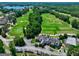 Beautiful aerial view of a neighborhood with a lush green golf course and clubhouse at 2360 Braunsroth Ln, Hampton, GA 30228