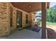 Inviting covered back porch with outdoor seating, perfect for relaxing and enjoying the outdoors at 2360 Braunsroth Ln, Hampton, GA 30228