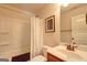 Small bathroom features a bathtub with shower, toilet, vanity and framed mirror at 2360 Braunsroth Ln, Hampton, GA 30228