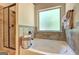 Relaxing bathroom showcases a soaking tub with a window, and a separate glass door shower at 2360 Braunsroth Ln, Hampton, GA 30228