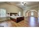 Bright and airy bedroom with hardwood floors, a large bed, and sitting area in the background at 2360 Braunsroth Ln, Hampton, GA 30228