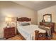 Bedroom with wood flooring features a bed, dresser, nightstand, and coordinated furnishings at 2360 Braunsroth Ln, Hampton, GA 30228