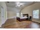 Spacious bedroom features a ceiling fan, wood flooring, and natural light through the windows at 2360 Braunsroth Ln, Hampton, GA 30228