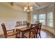Formal dining room featuring a stylish chandelier, large table, and windows at 2360 Braunsroth Ln, Hampton, GA 30228