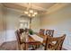 Elegant dining room with hardwood floors, wainscoting, coffered ceilings, and chandelier at 2360 Braunsroth Ln, Hampton, GA 30228